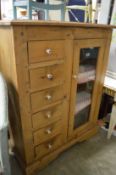 A small pine storage chest/cupboard.