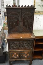 An unusual small carved oak cabinet.