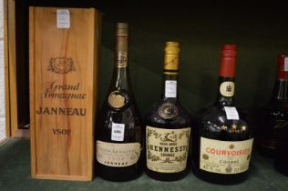 A bottle Janneau Armagnac, boxed together with an old bottle of Hennessy cognac and an old bottle of