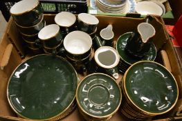 A quantity of French gilt decorated green glazed dinnerware.