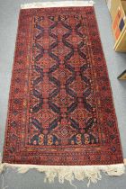 A Persian rug, deep blue ground with stylised decoration 180cm x 92cm.