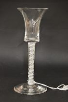 A Georgian wine glass with inverted bell shape bowl and white twist stem.