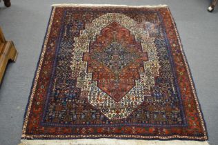 A good Persian design rug, rich red and blue ground with all over stylised decoration 150cm x