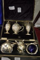 Two cased sets of silver cruets.