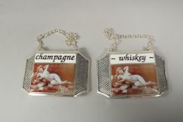 A pair of silver plate enamel whisky and champagne labels.