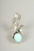A silver and naturalistic opal ring in a box.