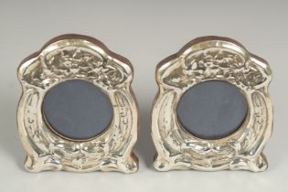 A pair of silver, shaped photograph frames, 110cm x 80cm.