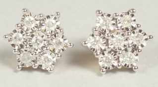 A superb 9ct. gold and diamond daisy cluster earrings in a box.