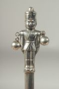 A silver novelty soldier rattle.
