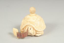 A carved bone tortoise tape measure.