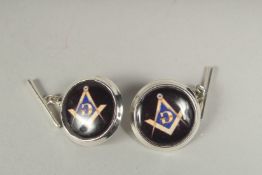 A pair of silver Masonic cufflinks in a box.