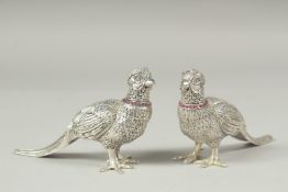 A pair of ruby collar pheasant salt and peppers, 11cm.