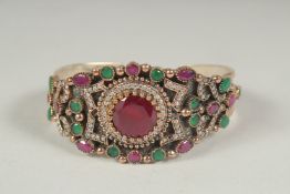 A wide silvered ruby chalcedony bangle, in a heart shaped velvet box.