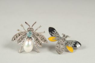 Two silver topaz pearl and emerald bee brooch in a box.
