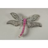 A silver and marcasite dragonfly brooch in a box.