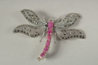 A silver and marcasite dragonfly brooch in a box.
