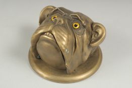 A bronze dogs head bell, 11cm wide.