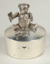 A novelty silver articulated teddy bear circular pill box, 3cm.