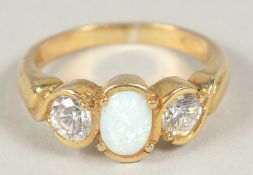 A silver gold plated cubic zirconia and opal ring in a box.