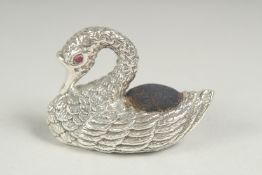 A silver swan pin cushion, 5cm long.