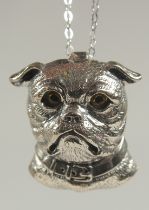 A silver pug dog brooch or pendant on a chain in a box.