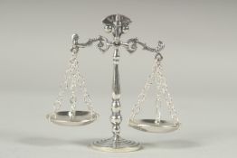 A miniature silver set of scales.