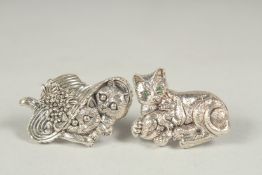 Two silver cat brooches in a box.