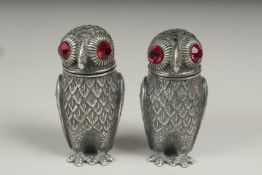 A pair of silver plated owl salt and peppers.
