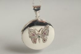 A silver locket and chain decorated with a butterfly in a box.