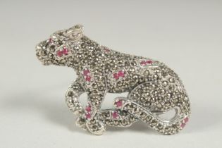 A silver marcasite and ruby panther brooch.