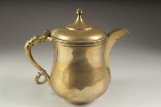 A FINE 19TH CENTURY INDIAN BRASS EWER, with a zoomorphic handle, 24cm high.