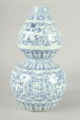 A CHINESE BLUE AND WHITE PORCELAIN DOUBLE GOURD VASE, 32cm high.