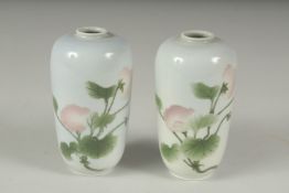 A PAIR OF JAPANESE PORCELAIN VASES, with floral decoration, each with blue mark to base, 11cm high.
