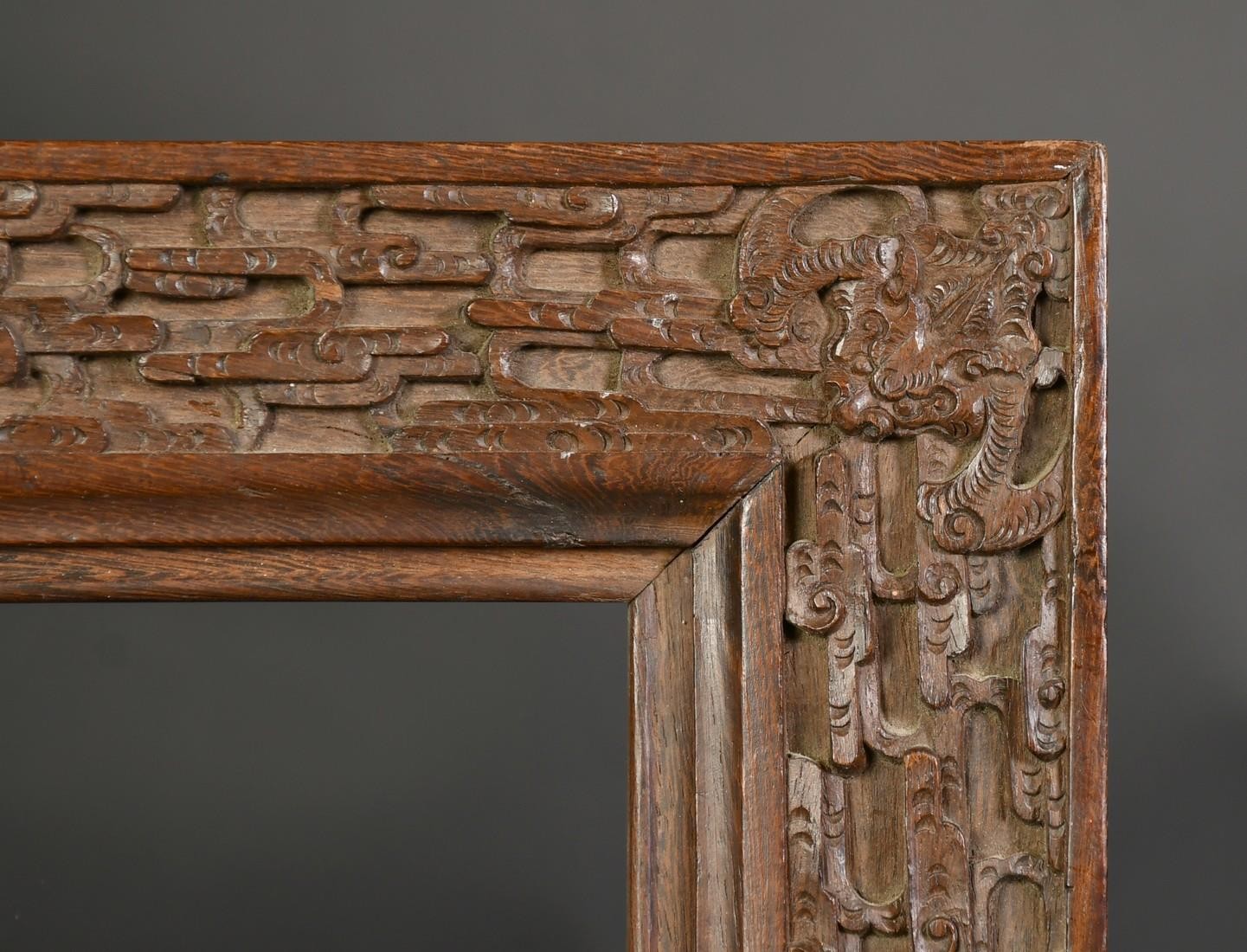 AN EARLY 20TH CENTURY CHINESE HARDWOOD FRAME, carved in an intricate design with bats and dragons, - Image 4 of 4