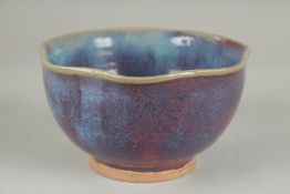 A CHINESE JUN WARE PORCELAIN BOWL, with wavey rim, 16.5cm wide.