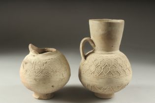 TWO 12TH CENTURY SYRIAN UNGLAZED POTTERY JUGS, tallest 21cm high, (2).
