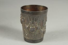 A CHINESE METAL BEAKER, relief decorated with flora, 6cm high.