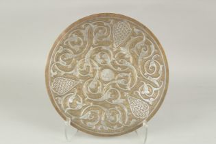 AN ISLAMIC SILVER INLAID BRASS DISH, 35cm diameter.