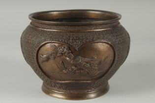 A JAPANESE BRONZE JARDINIERE, with relief panels of birds, 19cm diameter.