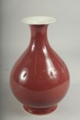 A CHINESE RED GLAZED PORCELAIN VASE, character mark to base, 23cm high.