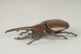 A JAPANESE BRONZE OKIMONO OF A HERCULES BEETLE, with opening back cover, 10.5cm long.