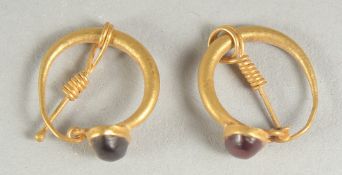 A PAIR OF BYZANTINE GOLD EARRINGS, inset with natural red garnets.