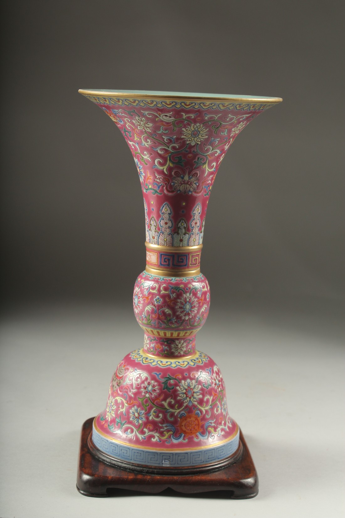 A CHINESE PINK GROUND FAMILLE ROSE PORCELAIN SECTIONAL GU VASE, and fitted hardwood stand, bearing - Image 7 of 10