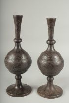 A NEAR PAIR OF 19TH CENTURY PERSIAN QAJAR SILVER INLAID ENGRAVED STEEL BOTTLE VASES, 35cm and 36cm