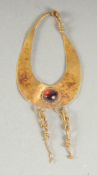 A BYZANTINE GOLD PENDANT, inset with natural red garnet.