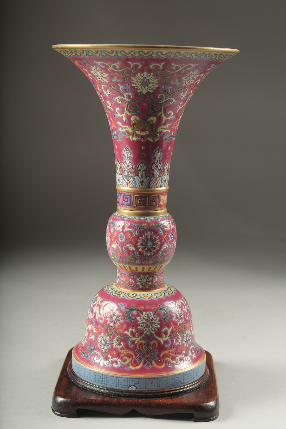 A CHINESE PINK GROUND FAMILLE ROSE PORCELAIN SECTIONAL GU VASE, and fitted hardwood stand, bearing - Image 5 of 10