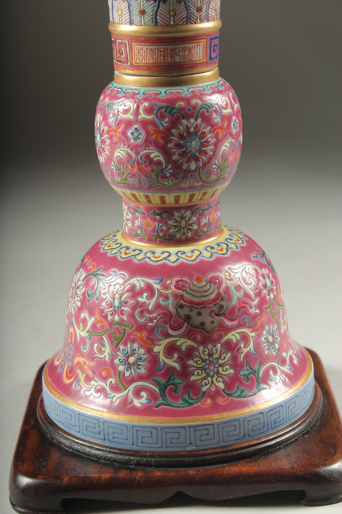 A CHINESE PINK GROUND FAMILLE ROSE PORCELAIN SECTIONAL GU VASE, and fitted hardwood stand, bearing - Image 3 of 10