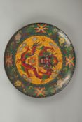 A CHINESE CLOISONNE DRAGON DISH, 25cm diameter.