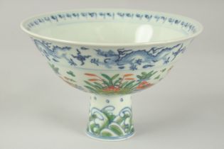 A CHINESE WUCAI PORCELAIN STEM CUP, painted with ducks and aquatic flora, bowl 17cm diameter.