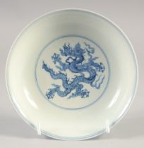 A CHINESE BLUE AND WHITE PORCELAIN DISH, decorated with dragons, bearing six-character mark, 15cm